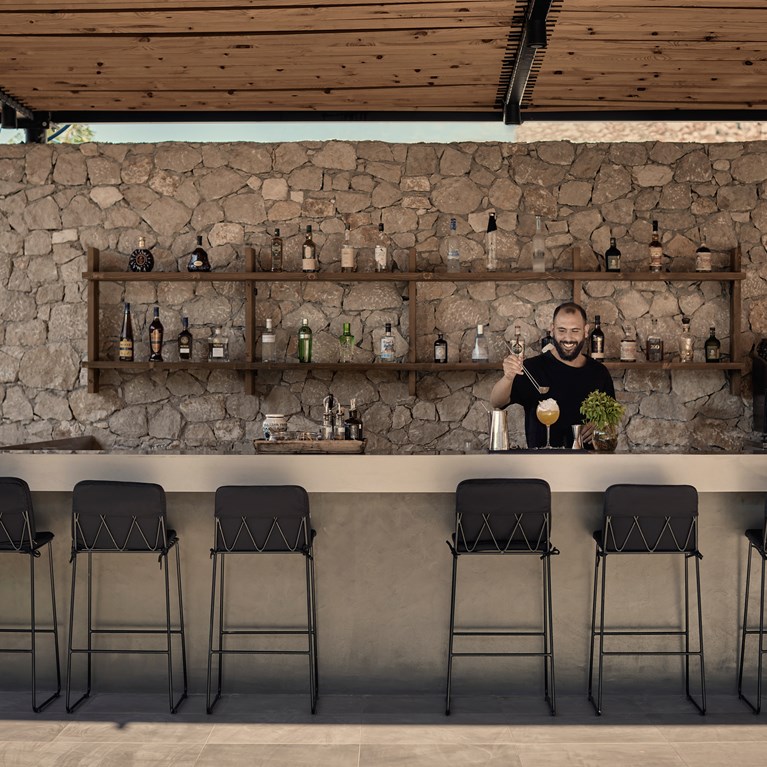 Casa Cook Rhodes Olive Restaurant with man serving cocktails