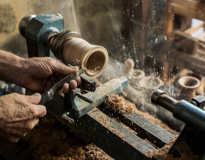 Casa Cook Rhodes Greece close up on man using woodworking tools to craft