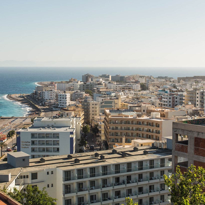Casa Cook Rhodes Greece city skyline of Rhodes showing the high rise hotels, clear blue sky, beach and ocean