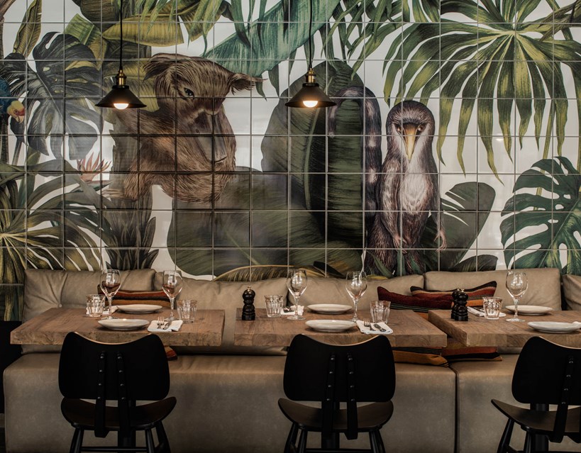 Casa Cook Rhodes Greece Kitchen Club Restaurant seating with tropical forest and animal wallpaper behind the table
